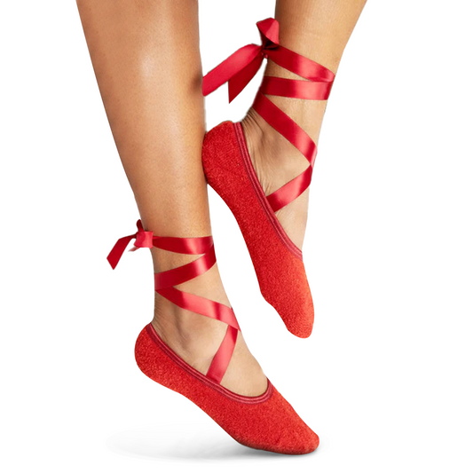 Red fuzzy ballet slipper socks with satin ribbon, a cozy gift for her